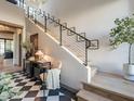 Stylish entryway with a modern staircase, decor, and black and white tiled floors at 3955 E Sierra Vista Dr, Paradise Valley, AZ 85253