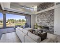Bright living room with stone fireplace, comfortable seating, and sliding doors to the outdoor patio at 37200 N Cave Creek Rd # 2110, Scottsdale, AZ 85262