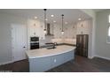 Modern kitchen with a large island, stainless steel appliances, and plenty of cabinet space at 26405 N 19Th Dr, Phoenix, AZ 85085