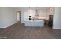 A spacious kitchen and living area with modern appliances and a large kitchen island at 26405 N 19Th Dr, Phoenix, AZ 85085