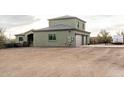 Exterior view of the home's three-car garage, basketball court, and desert landscape at 38334 N 20Th St, Phoenix, AZ 85086