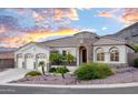 Inviting exterior view showcasing the home's architecture, desert landscaping, and three-car garage at 16002 S 27Th Dr, Phoenix, AZ 85045