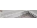 Close up on white baseboards and light grey wood look flooring at 19655 E Estrella Rd, Queen Creek, AZ 85142
