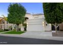 Two-story house with a landscaped front yard and garage at 1521 W Commerce Ave, Gilbert, AZ 85233