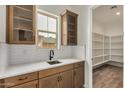 Butler Pantry with cabinets, sink and countertop. Large walk in pantry also shown at 19679 E Estrella Rd, Queen Creek, AZ 85142