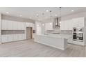 Bright and modern kitchen with a large center island, stainless steel appliances, and ample cabinet space at 21921 S 197Th St, Queen Creek, AZ 85142