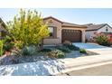 Front view of a one-story house with mature trees and gravel landscaping at 12179 E Sereno Rd, Gold Canyon, AZ 85118