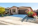 Charming one-story home with red flowers and gravel landscaping at 12179 E Sereno Rd, Gold Canyon, AZ 85118