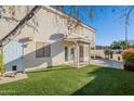 Spacious backyard with grassy lawn, covered patio, and outdoor grilling area at 7 W Sarah Ln, Tempe, AZ 85284