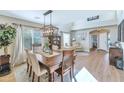 Dining room features a wood table, light chandelier, large windows, and seamless flow to the living area at 2920 E Shady Spring Trl, Phoenix, AZ 85024