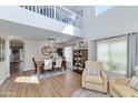Bright dining room boasts high ceilings, a modern chandelier, and large windows for ample natural light at 2920 E Shady Spring Trl, Phoenix, AZ 85024