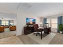 Bright home office features a large desk, comfortable chair, and views into the living area at 17214 W Gibson Ln, Goodyear, AZ 85338