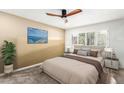 Spacious bedroom with neutral tones, ceiling fan, and large window at 4701 N 68Th St # 129, Scottsdale, AZ 85251