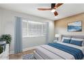 Comfortable bedroom with ceiling fan, window with blinds, and stylish decor at 4701 N 68Th St # 129, Scottsdale, AZ 85251