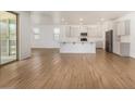 Open kitchen with island and hardwood floors, overlooking the living room at 19031 W Palo Verde Dr, Litchfield Park, AZ 85340