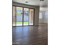 Bright open-plan living room with tile floors and sliding door access to the backyard at 19031 W Palo Verde Dr, Litchfield Park, AZ 85340