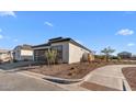 This modern single-Gathering home boasts low-maintenance desert landscaping and sleek architectural design at 4353 N 203Rd Ave, Buckeye, AZ 85396