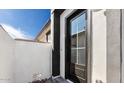 Exterior doorway featuring glass door and white and black facade at 20311 W Montecito Ave, Buckeye, AZ 85396