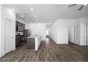 Modern kitchen with stainless steel appliances, center island, and wood flooring at 24606 W St Catherine Ave, Buckeye, AZ 85326