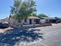 Street view of a cozy single-story home with a brick fence and a large tree at 5559 N 62Nd Ave, Glendale, AZ 85301