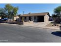 Simple single-story house with a carport and minimal landscaping at 5559 N 62Nd Ave, Glendale, AZ 85301