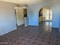 Open living room with tiled floors and an arched doorway at 5559 N 62Nd Ave, Glendale, AZ 85301