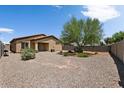 Large backyard with gravel and a mature tree at 42459 W Paseo Dr, Maricopa, AZ 85138