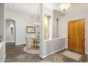 Bright entryway with tile flooring, a wooden door, and a small dining area at 323 W Quartz Rock Rd, Phoenix, AZ 85085