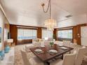 Bright living room with lots of natural light, nice furniture, wood paneling and a formal dining table for six at 120 N Val Vista Dr # 264, Mesa, AZ 85213