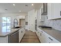 Modern kitchen with white cabinets, stainless steel appliances, and quartz countertops at 260 S 165Th Ave, Goodyear, AZ 85338