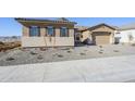 New construction home with a two-car garage and desert landscaping at 6722 N 190Th Dr, Waddell, AZ 85355