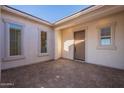 Covered entryway with tile flooring and neutral-colored walls at 19014 W Ocotillo Rd, Waddell, AZ 85355