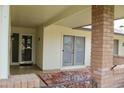 Inviting porch with brick accents, tiled flooring, and ample space for outdoor seating at 10931 W Peoria Ave, Sun City, AZ 85351