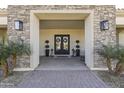 Elegant entryway with double doors and stonework at 18223 W Rancho Ct, Litchfield Park, AZ 85340