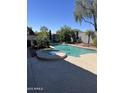 Inviting pool and spa area with a relaxing water feature and beautiful landscaping at 17218 N Melissa Ln, Surprise, AZ 85374