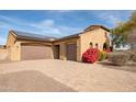 House exterior with solar panels, double garage, and landscaping at 18206 W Sells Dr, Goodyear, AZ 85395