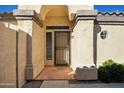 Front entrance with arched entryway and security door at 14535 W Zuni Trl, Surprise, AZ 85374