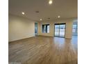 Bright living room with beautiful tile floors, recessed lighting, and large windows at 16994 W Canterbury Dr, Surprise, AZ 85388