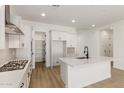 Stylish kitchen featuring a large island, white cabinetry, stainless steel appliances, and plenty of counter space at 11934 W Parkway Ln, Avondale, AZ 85323