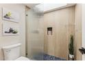 Bathroom with a modern glass shower, stylish tile and spa-like decor at 3059 E Rose Ln, Phoenix, AZ 85016