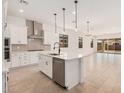 Open-concept kitchen featuring a center island with seating and stainless steel appliances at 12007 W Parkway Ln, Avondale, AZ 85323