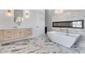 Spa-like bathroom with a soaking tub, fireplace, modern vanity, and stylish marble flooring at 32278 N 168Th Ave, Surprise, AZ 85387