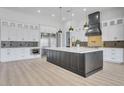 Gourmet kitchen with stainless steel appliances, a large island, and modern backsplash design at 32278 N 168Th Ave, Surprise, AZ 85387