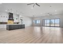 Open-concept living space featuring a modern kitchen, island, and large sliding glass doors with desert views at 32278 N 168Th Ave, Surprise, AZ 85387