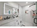 Modern bathroom features double sinks, white tile, a glass shower, and a lighted mirror at 2236 E Blanche Dr, Phoenix, AZ 85022