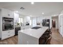 Bright kitchen featuring white cabinetry, a large center island, and stainless steel appliances at 2236 E Blanche Dr, Phoenix, AZ 85022