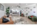 Open-concept living space with modern furnishings, a stylish rug, and a view of the kitchen at 2236 E Blanche Dr, Phoenix, AZ 85022