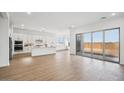 Open concept kitchen with island, stainless steel appliances, and light wood flooring at 22886 E Alyssa Rd, Queen Creek, AZ 85142