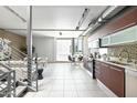 Modern open-concept floorplan features dining, kitchen, and living areas with an open steel staircase at 520 S Roosevelt St # 1009, Tempe, AZ 85281