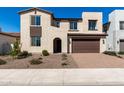 Charming two-story home featuring a brick driveway and a beautifully landscaped front yard at 18002 W Vogel Ave, Goodyear, AZ 85338